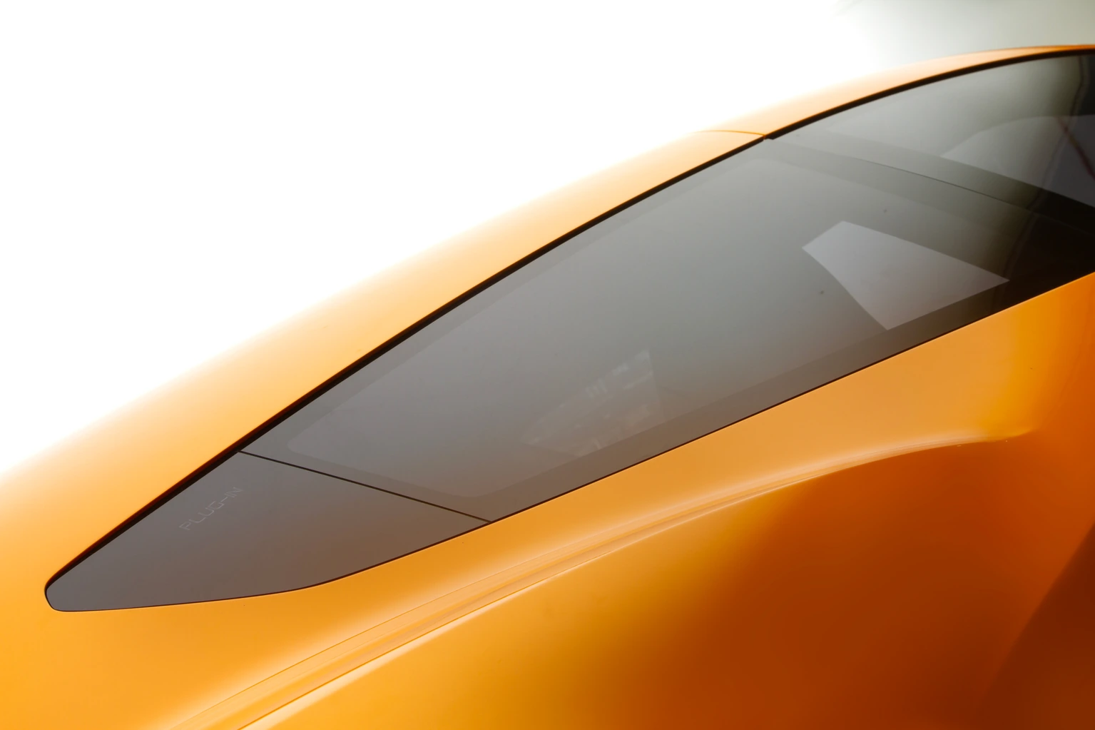 Tinted glass curving into the yellow roofline
