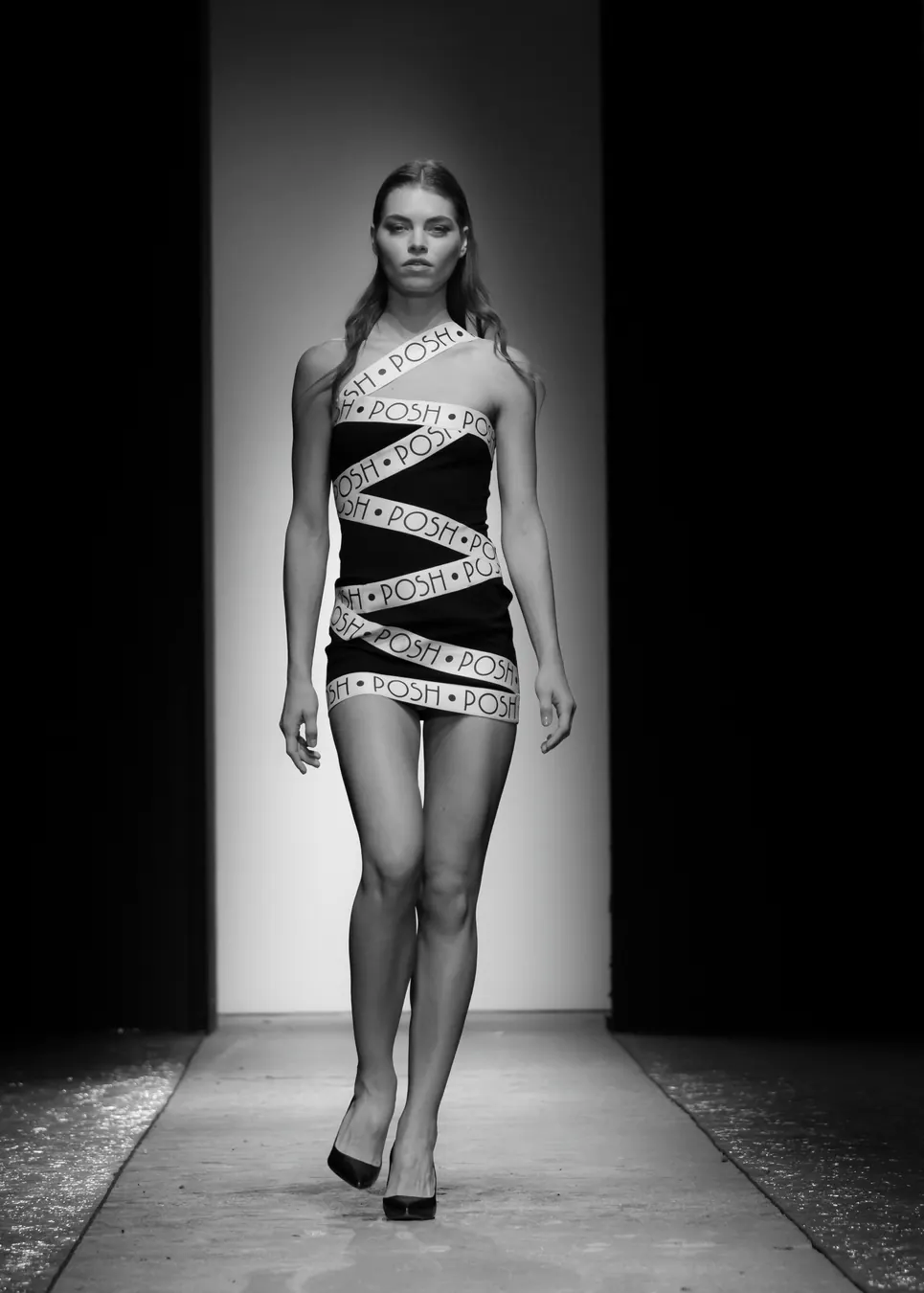Black mini dress wrapped in printed ribbon on the runway